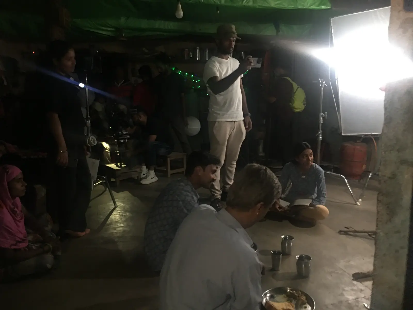 Crew and performers gathered around an interior lighting setup
